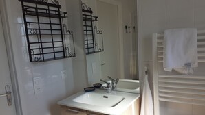 A bathroom with a white sink, mirror, and towel rack. - Chuchotis, apartment for 4 with balcony and parking space (LE Crotoy)
