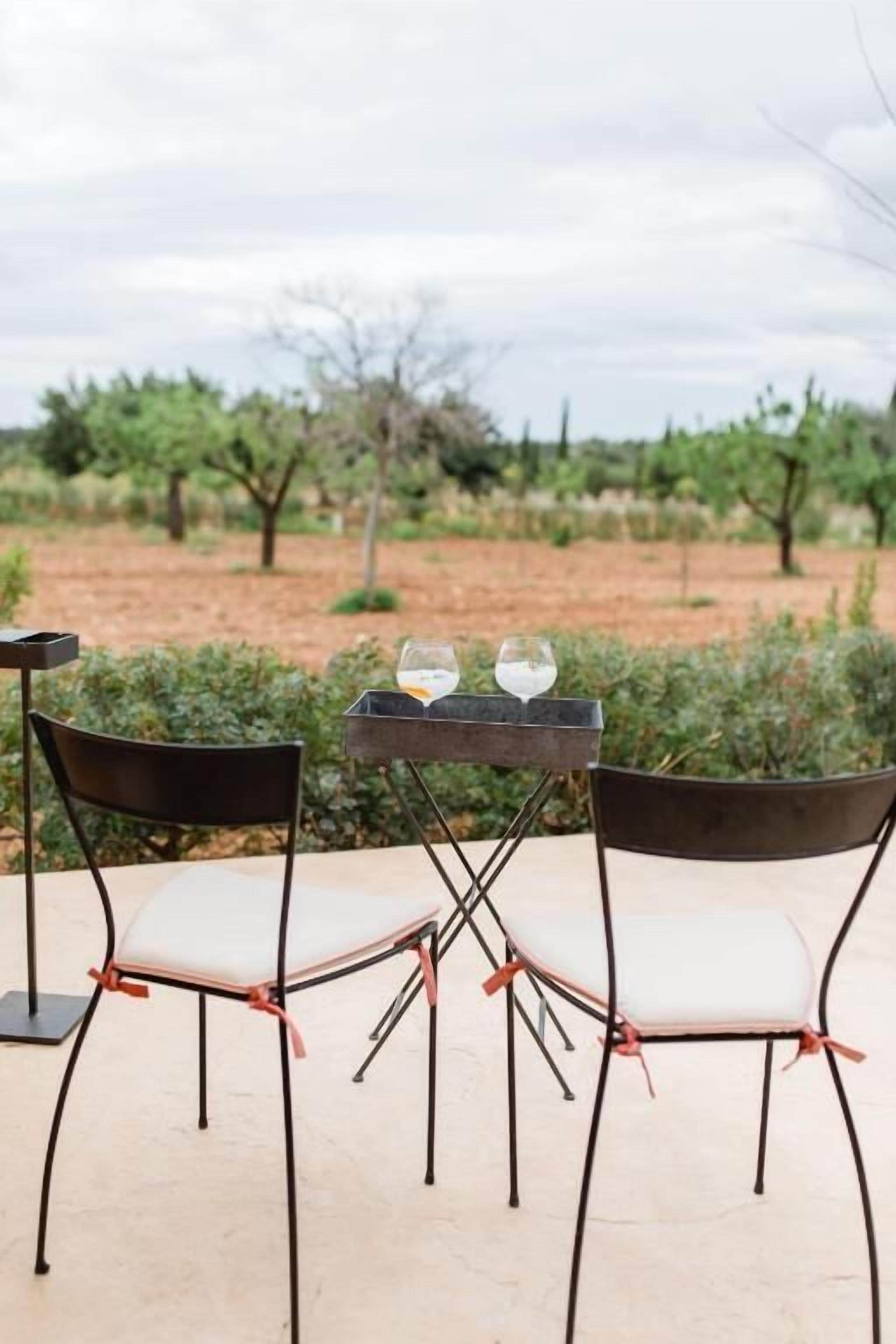 A table with two chairs and two glasses.