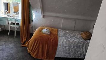 Une chambre à coucher avec un lit, un bureau et une chaise.