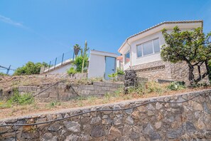 A stone retaining wall, a cactus, and a house with a tiled roof. - Newly renovated villa near the beach with a private... Pool, panoramic terrace, and 4 bedrooms (Velilla-Taramay)