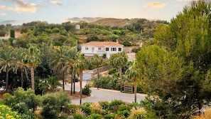 A white building with a red roof, surrounded by lush greenery and a road. - Newly renovated villa near the beach with a private... Pool, panoramic terrace, and 4 bedrooms (Velilla-Taramay)