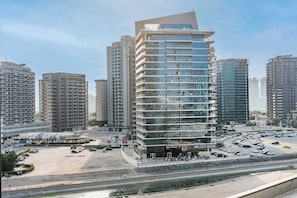 A multi-story building with a modern design, surrounded by other high-rise buildings. - StayShort - Cozy Studio in Sports City that Sleeps 3 (Sports City)