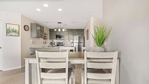 A modern kitchen with grey cabinets, stainless steel appliances, and a central island. - Sunset Ridge Private Patio (Lake Ozark)