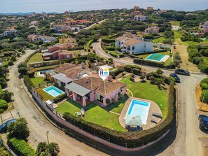 A residential area with houses, a swimming pool, and a road. - Villa With a Private Pool and sea View (Stintino)