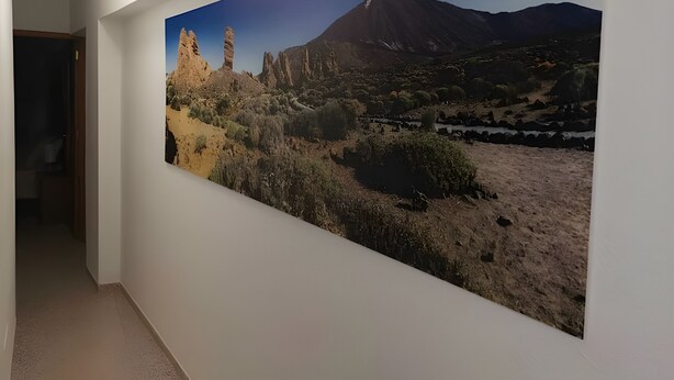 A hallway with a large landscape painting on the wall. - A charming refuge in San Telmo (Puerto de la Cruz)