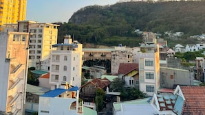 A cityscape with buildings, a prominent statue on a hill, and a clear sky. - Sunny Hotel Vung Tau (Ho Chi Minh City)