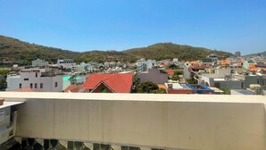 A residential area with buildings, a hill, and a clear sky. - Sunny Hotel Vung Tau (Ho Chi Minh City)