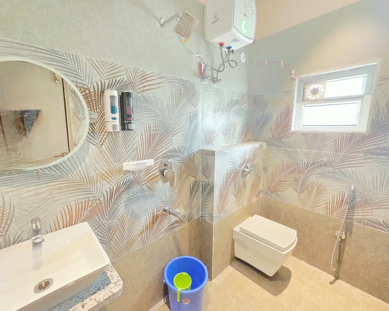 A bathroom with a shower, toilet, sink, and a mirror.