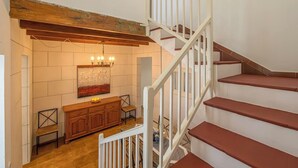 A staircase with white railings and wooden steps, leading to an upper floor. - Casa Major by 3 Villas Menorca (Fornells)