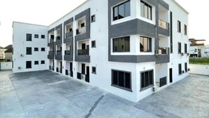 A modern multi-story building with a flat roof and a courtyard. - Jasmine Chidera Apartments (Lagos)