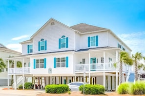 A two-story house with a balcony and a covered porch. - Pelican Manor B (North Myrtle Beach)