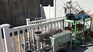 A wooden deck with potted plants and a white fence. - Private basement walkout in welcoming Huntington Station perfect for your stay (Huntington Station)