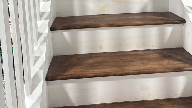 A staircase with white railings and wooden steps. - Private basement walkout in welcoming Huntington Station perfect for your stay (Huntington Station)