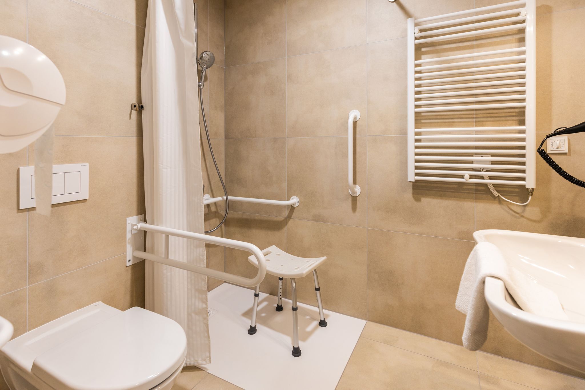 A bathroom with a shower, toilet, and sink.