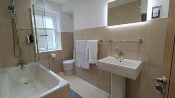Combined shower/bathtub, deep-soaking bathtub, hair dryer, towels
