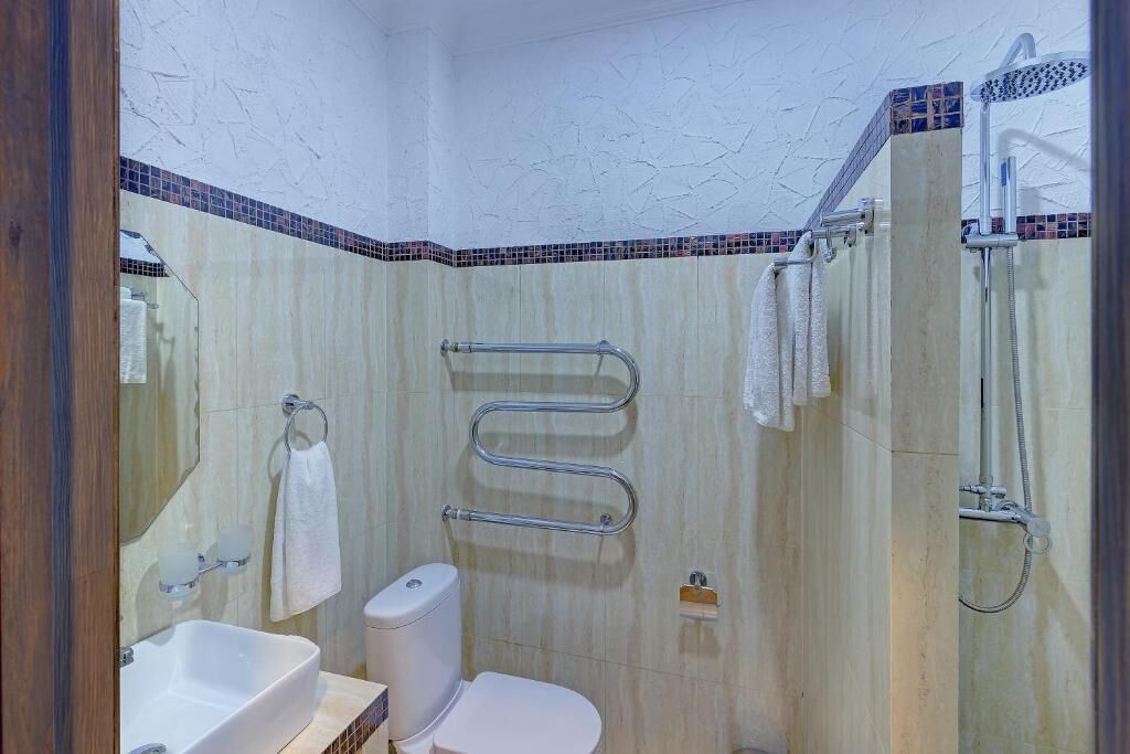 A bathroom with a sink, toilet, and shower.