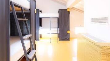 Un intérieur moderne avec des lits superposés, une échelle et un plancher jaune.