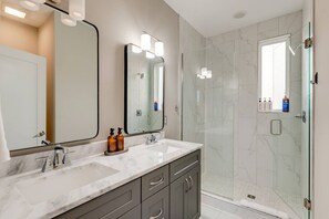 A modern bathroom with two sinks, a large mirror, and a glass-enclosed shower. - Rooftop Skyline View-Close to Broadway-Sleeps 8 (Nashville)