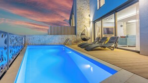 A swimming pool with lounge chairs, a stone wall, and a sunset view. - Ultra-modern vacation home for 6 with swimming pool in Crikvenica (Crikvenica)