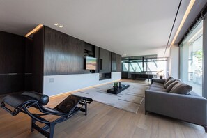 A modern living room with a sofa, a recliner, a coffee table, and a TV mounted on the wall. - Beautiful private villa for 10 guests with A/C, WIFI, private pool, TV and patio, close to Arezzo (Subbiano)