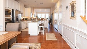 A spacious kitchen with white cabinetry, stainless steel appliances, and a central island. - Waterfront Resort | Community Amenities | Sleeps 13 (Selbyville)