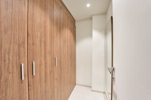 A hallway with wooden wardrobes and a door. - Stylish Mercury Suites Apartment  With Rooftop Pool (Saint Julian's)
