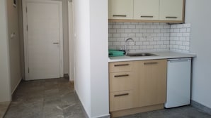 A kitchen with a dishwasher, a sink, and cabinets. - m2 otel (Bodrum)