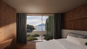 A bedroom with a large bed, wooden panel walls, and a view of the sea. - Romeo Massa Lubrense (Massa Lubrense)