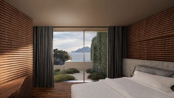 Une chambre avec un grand lit, des murs lambrés et une vue sur la mer.