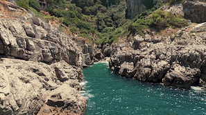 A rocky canyon with a narrow water channel and a staircase leading up. - Romeo Massa Lubrense (Massa Lubrense)