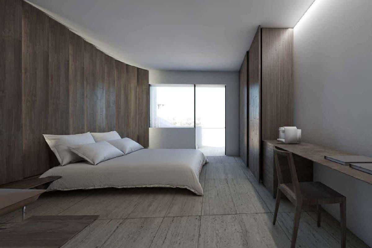 Ein modernes Schlafzimmer mit einem Bett, einem Schreibtisch und einem Fenster.
