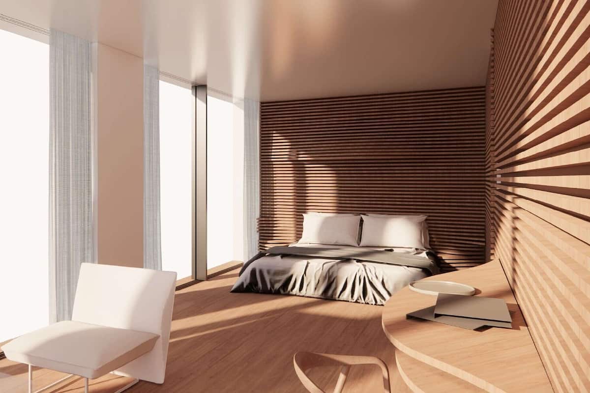 Ein modernes Schlafzimmer mit einem Bett, einem Sessel, einem kleinen Tisch und einem großen Fenster.