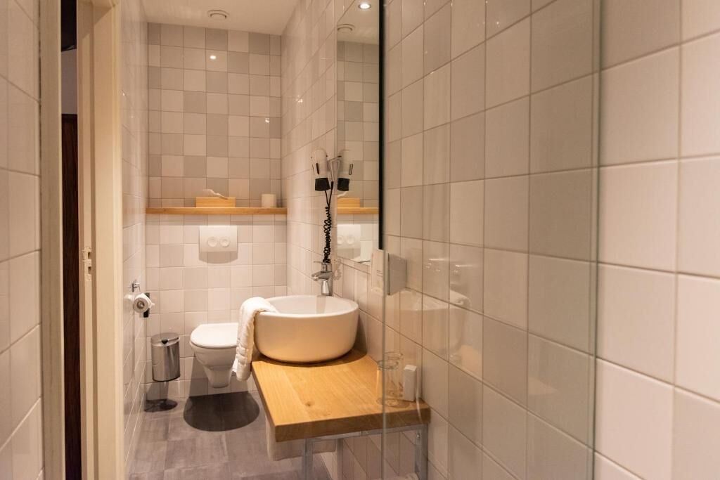 Ein modernes Badezimmer mit Toilette, Waschbecken und Duschbereich.