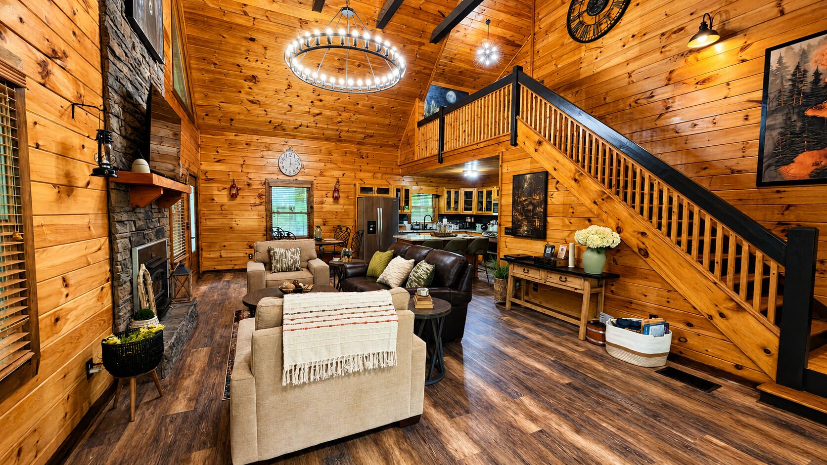 A log cabin interior with a living room, kitchen, and staircase.
