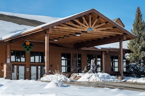 A wooden building with a covered entrance and a snow-covered landscape. - 643 Silvercreek Inn Condo The Escape Studio loft private balcony with views (Granby)