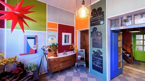 A room with a wooden cabinet, a chair, a red star decoration, and a chalkboard with writing. - "Sunshine" in harmony and color (Quedlinburg)