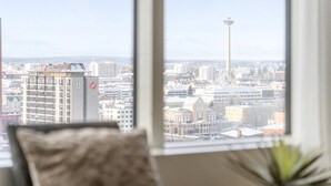 A cityscape through a window with a building featuring a red logo. - Nokia Arena By Come in! Deluxe Family Room (Tampere)