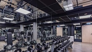 A gym with rows of dumbbells, weight machines, and mirrors on the walls. - 2 Spacious Wellness Retreat | Spa, Pool & Resort Access | Beach & Nature Park (Kamperland)