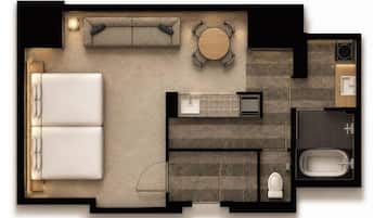 Distribución de una habitación de hotel con cama, sofá, mesa de comedor, baño y kitchenette.
