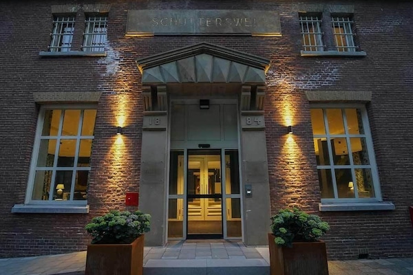 Step inside through the welcoming entrance glowing in evening light.