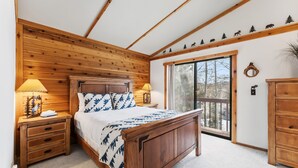 A bedroom with a wooden bed, nightstands, a window, and a view of the outdoors. - Frisco Mountain Home | Clubhouse, Pool & Hot Tubs Nearby (Frisco)