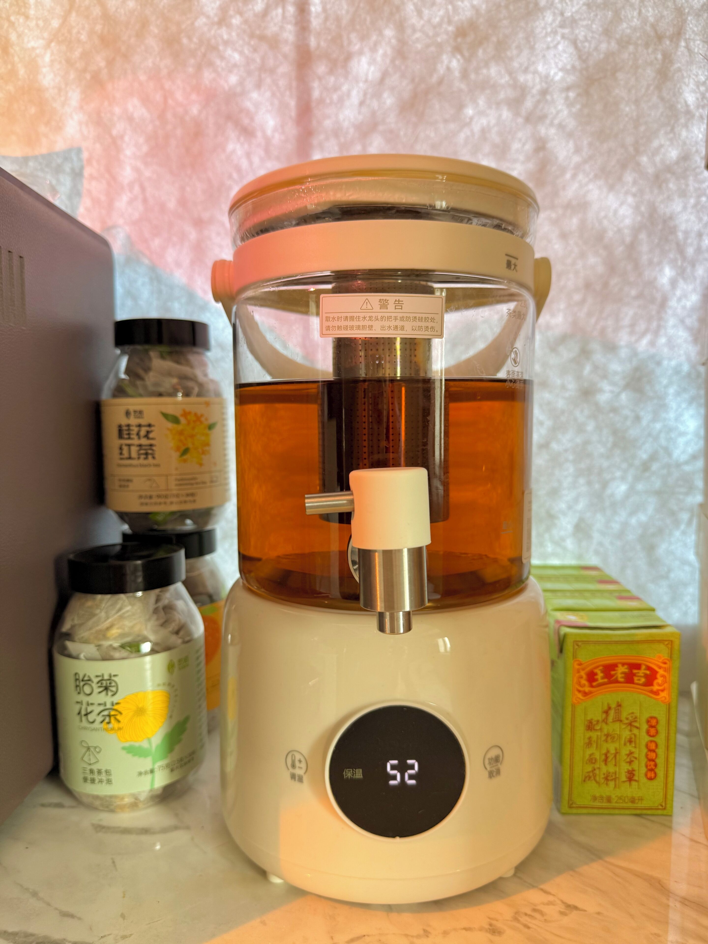 A kitchen with a food processor, a digital thermometer, and various food containers.