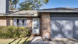 A residential house with a garage, brick exterior, and a front door. - Families w/ Pets! Emerald Coast Home 9 Mi to Beach (Fort Walton Beach)