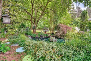 A garden with a pond, stepping stones, and a lantern. - Hot Tub, Home Gym, Decks! Retreat 9 Mi to Mt Airy (Ararat)