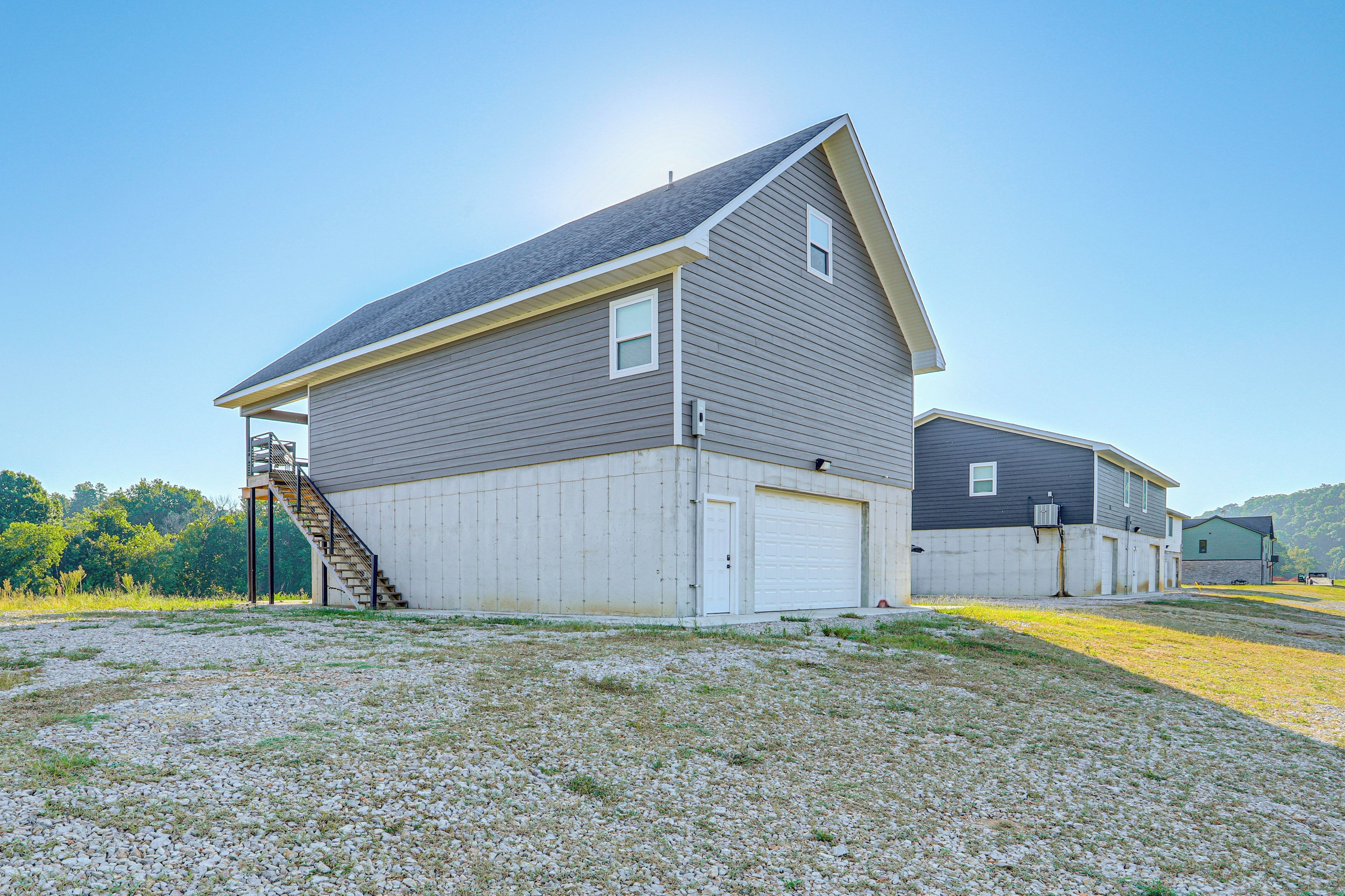 A two-story house with a garage, a staircase leading to the upper floor, and a driveway.
