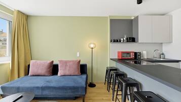 Comfort Apartment | Living area | 50-inch Smart TV with satellite channels, Netflix, heated floors
