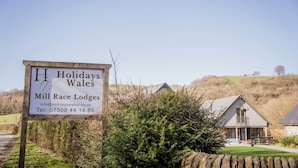 A sign for Holidays Wales Mill Race Lodges with contact information. - Oak Lodge (Knighton)
