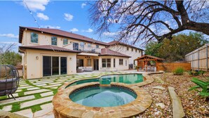 A two-story house with a swimming pool, a patio, and a wooden deck. - 1110 Terjo Ln (Austin)