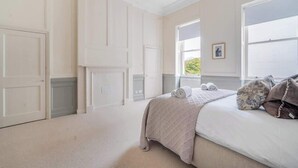 A bedroom with a bed, a window, and a door. - Modern Comfort in a Classic Bath Setting - VAT Q (Bath)