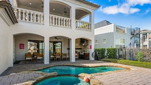 A two-story building with a swimming pool, outdoor seating, and a covered patio. - 7811 Palmilla Court (Kissimmee)